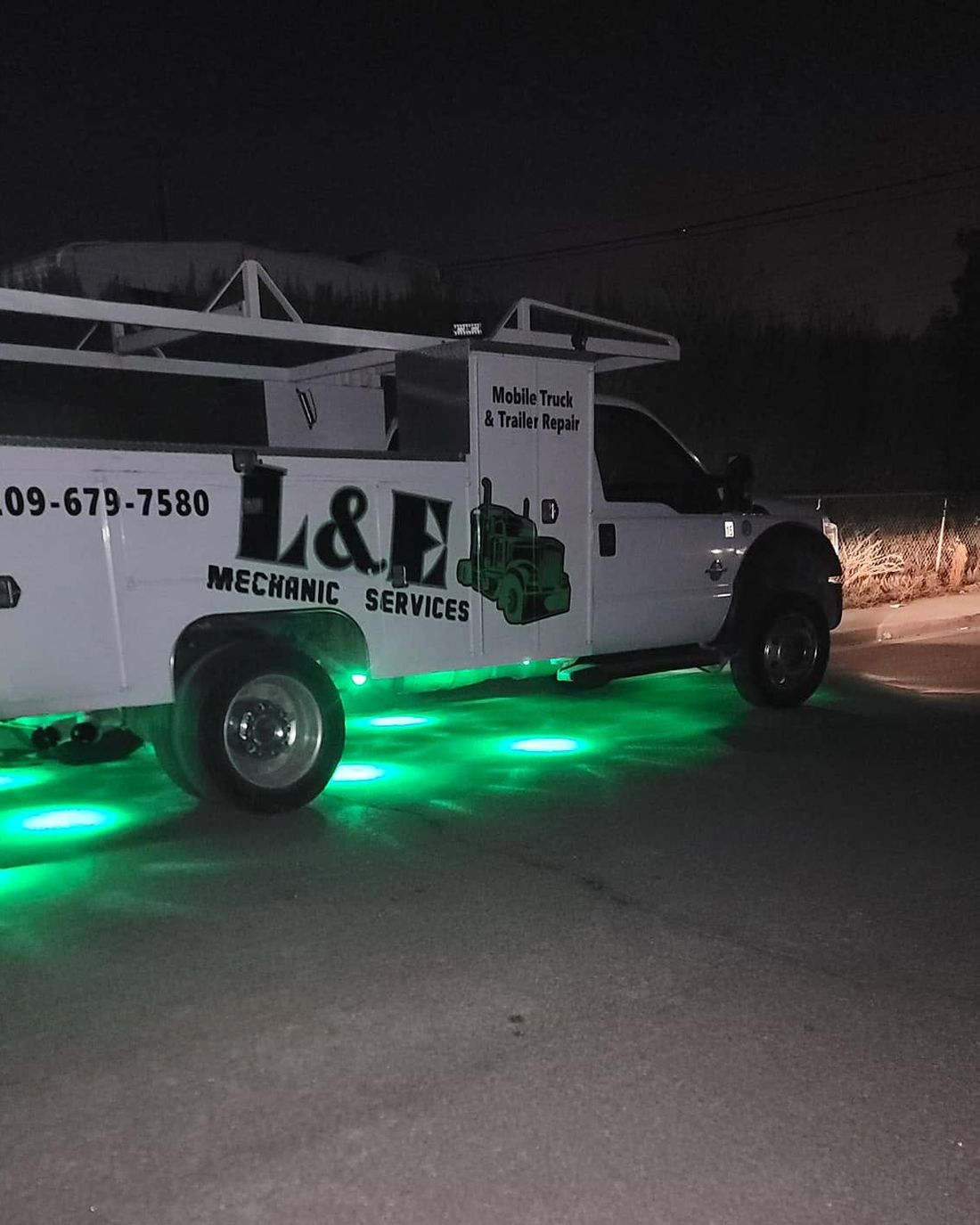 L&E Mechanics Services mobile service truck lit up at night, ready for a 24-hour call