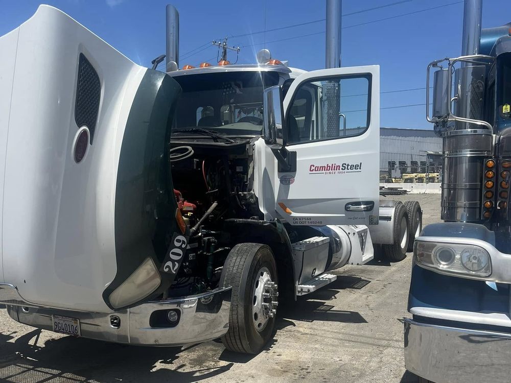 Semi truck with its hood open for repair by L&E Mechanics Services